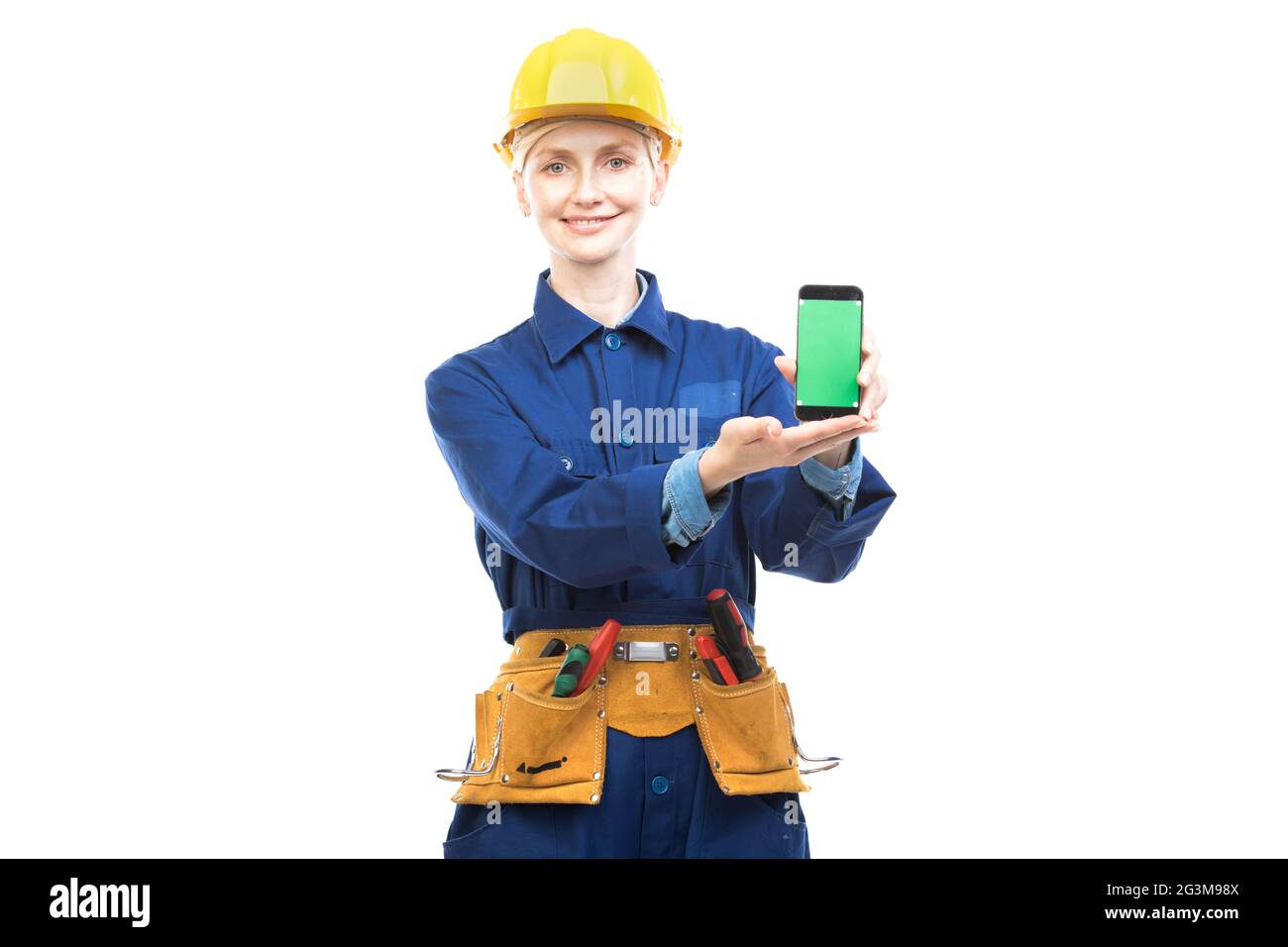 Horizontal medium portrait of modern professional female construction worker wearing blue uniform demonstrating mobile app on smartphone screen Stock Photo