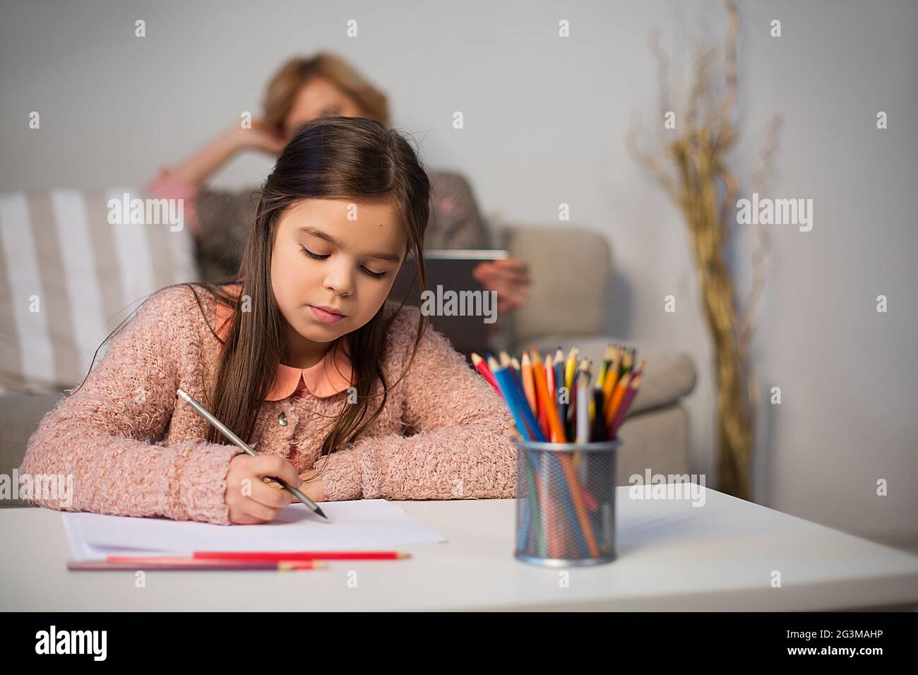 Little girl drawing with pencils Stock Photo - Alamy