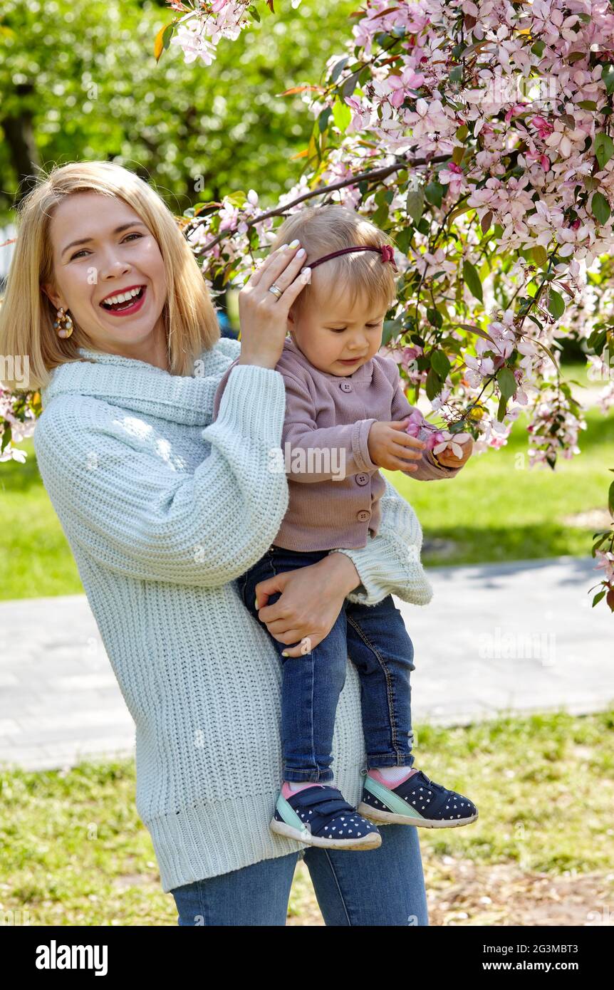 Mom and daughter on nature walk at spring park. Little girl and mother have a good time on weekend activity Stock Photo