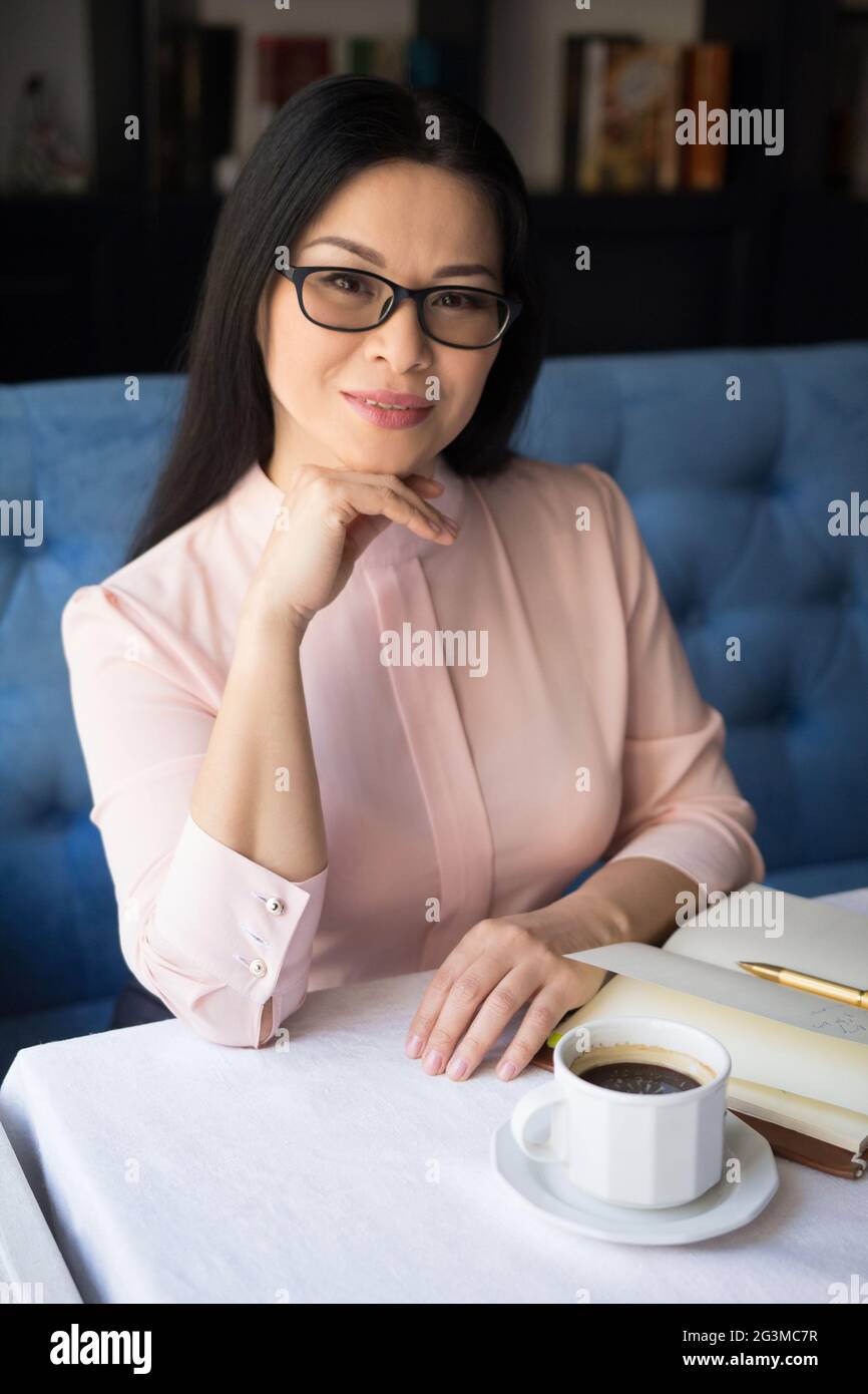 Beautiful young woman making notes Stock Photo