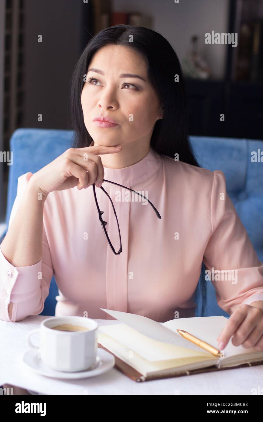 Beautiful young woman making notes Stock Photo