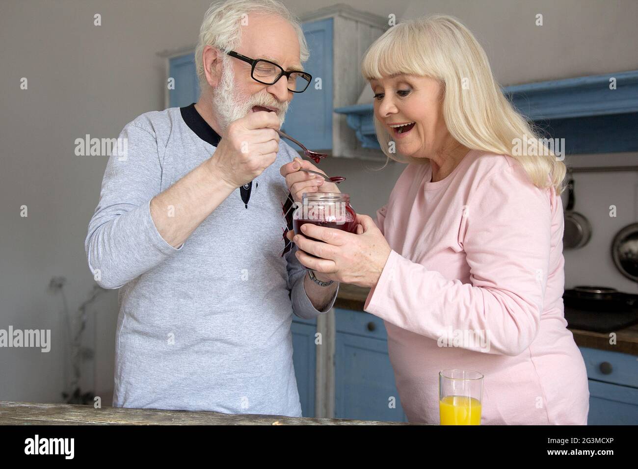 Elderly couple cooking in kitchen. Stock Photo