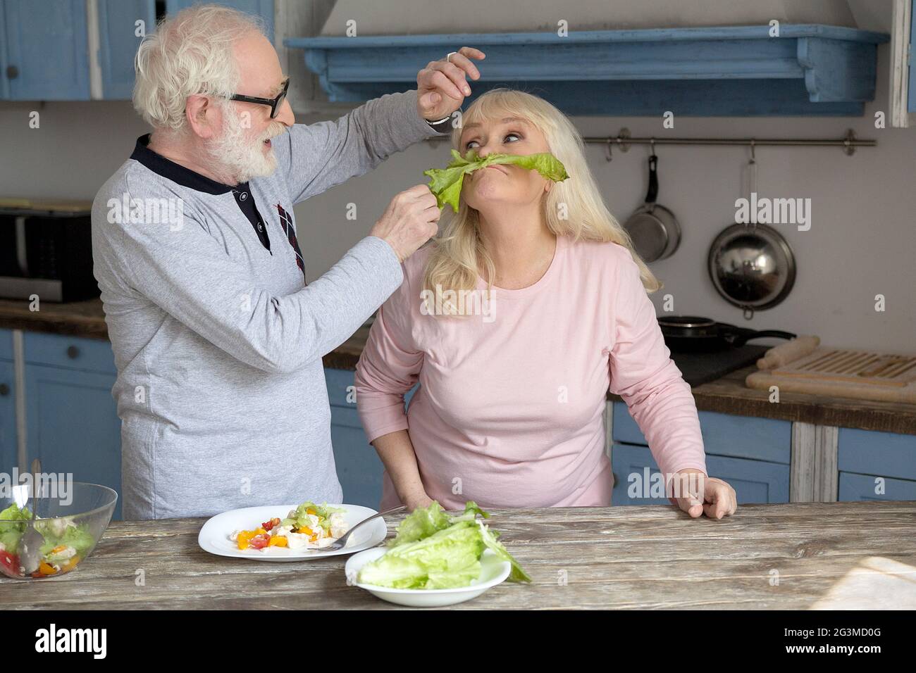 Elderly couple having fun in kitchen. Stock Photo