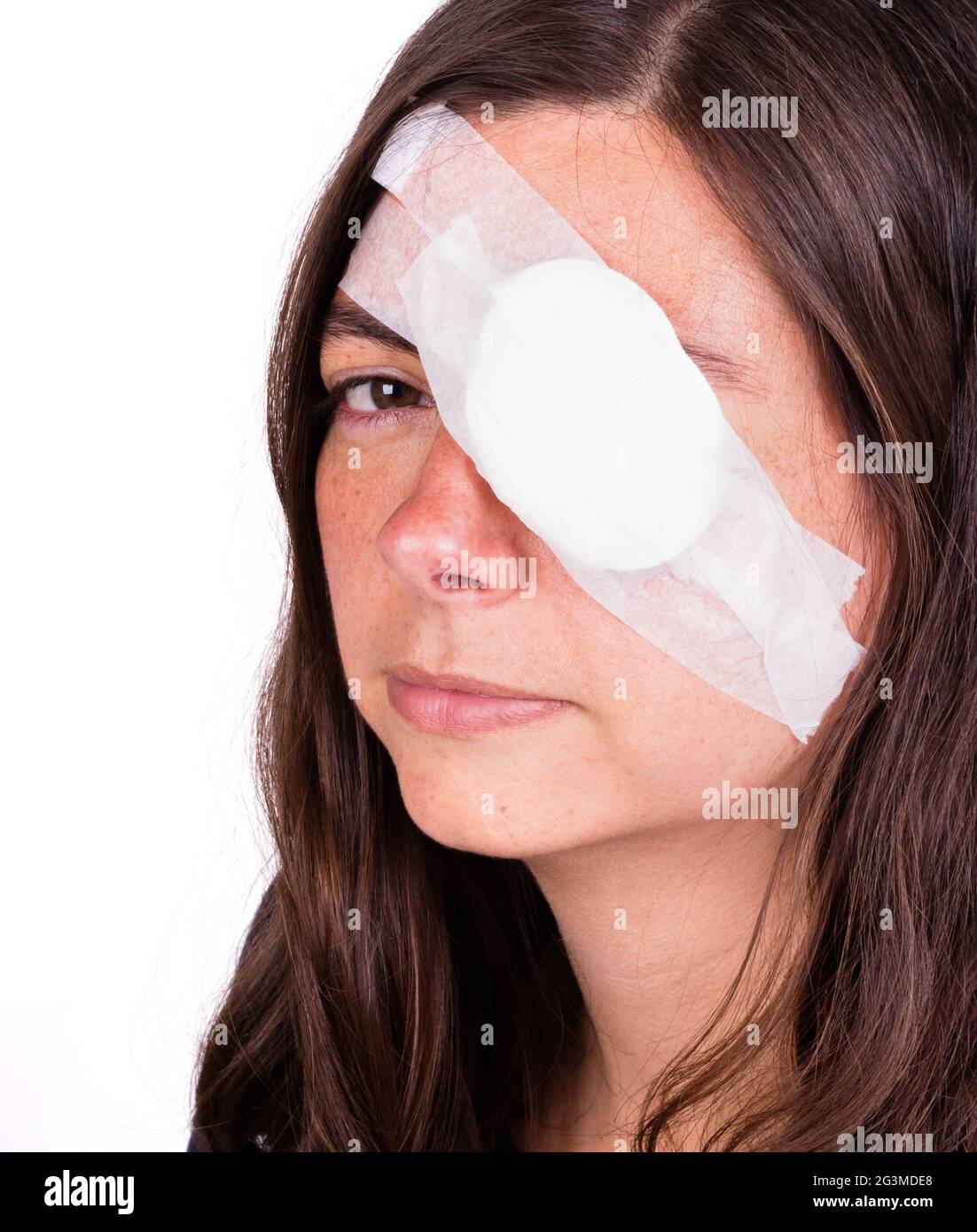 Portrait of woman wearing eye patch as protection after injury Stock
