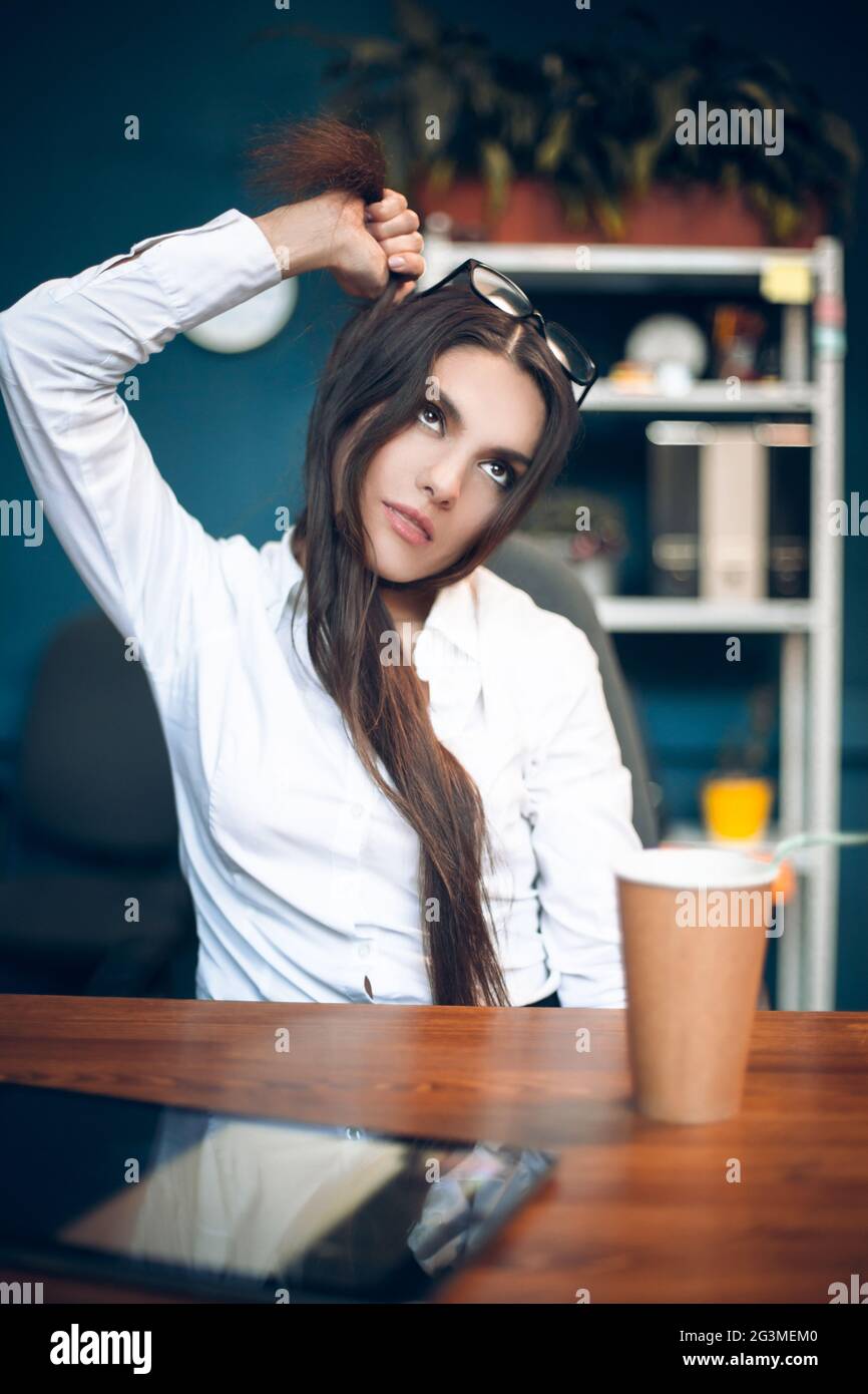 Business lady strangling herself with hair. Stock Photo