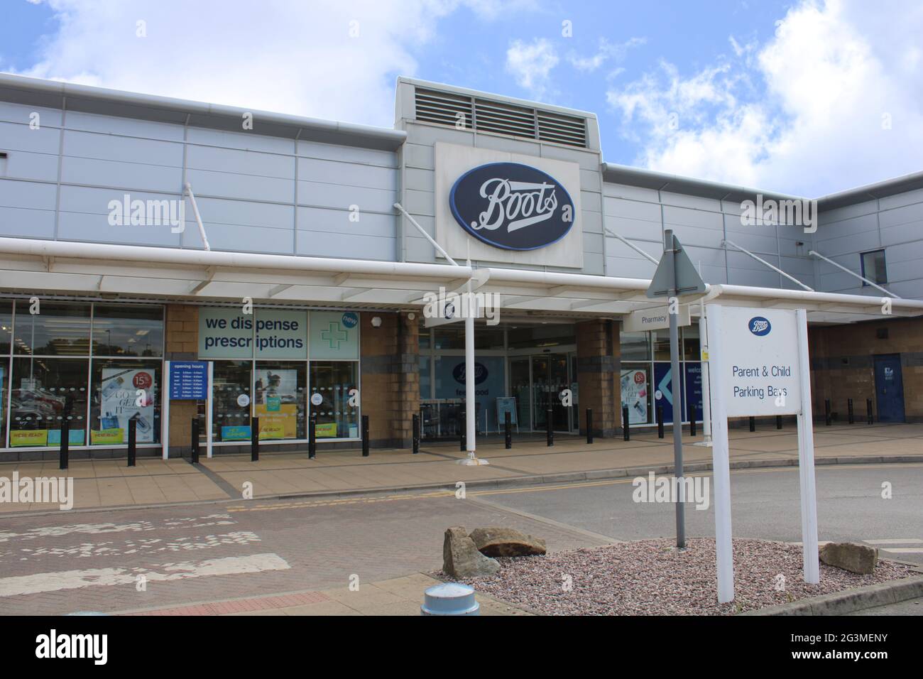 Boots store front with parent and child parking bay sign UK Stock Photo