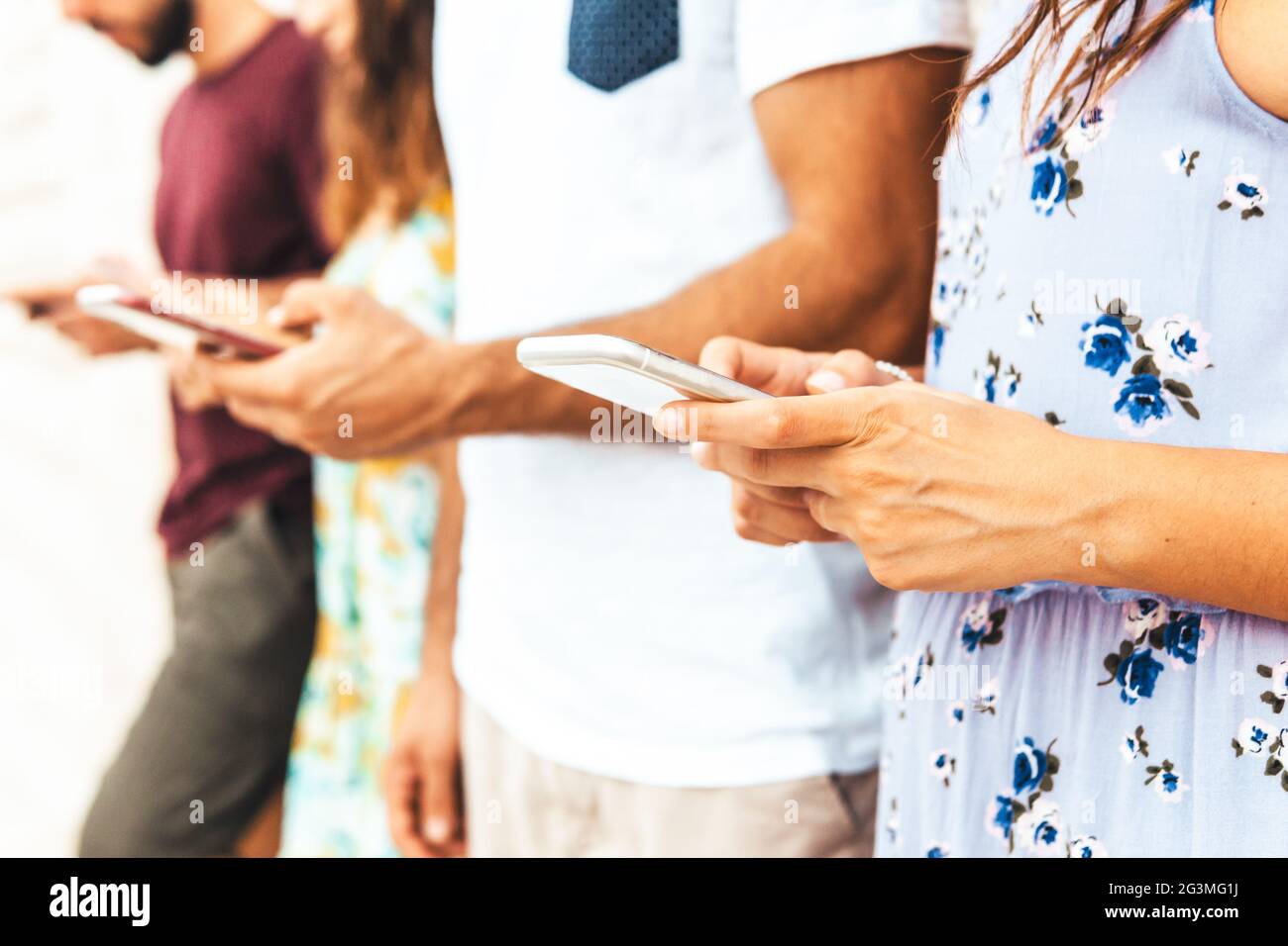 Using Internet With Friends Photo Group of friends using smartphone outdoors - Young people spend time ...