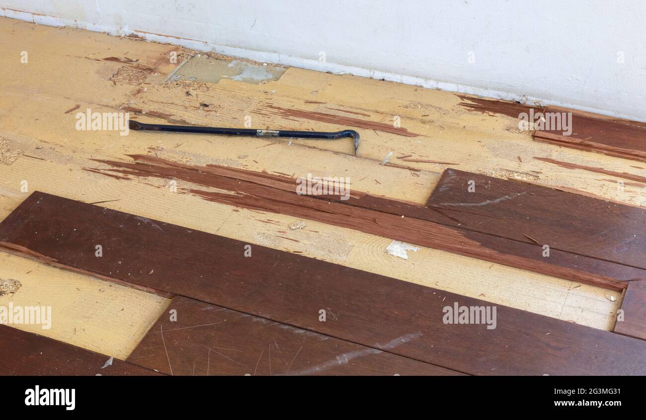 Breaking up a solid wooden floor Stock Photo Alamy