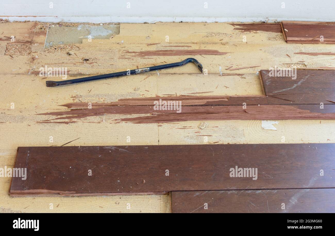 Breaking up a solid wooden floor Stock Photo Alamy
