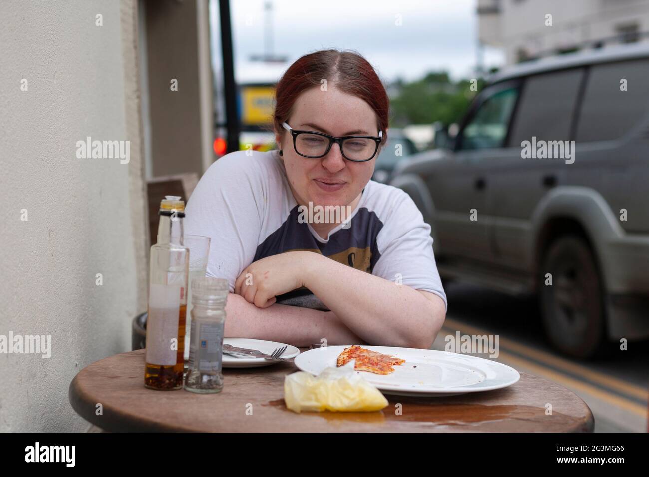 Young Millennial woman at outdoor cafe Stock Photo