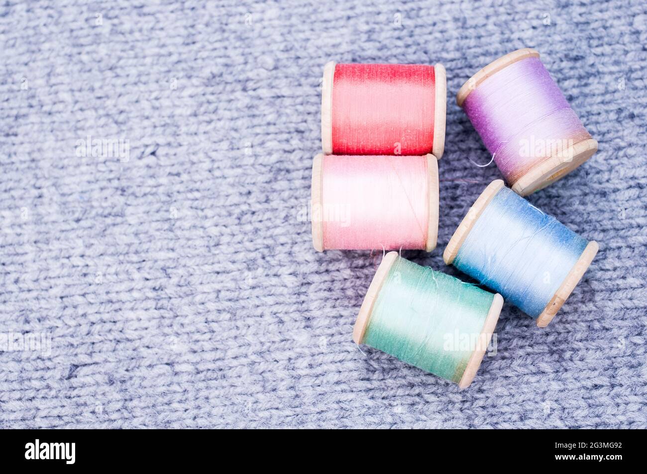 Colorful sewing threads on a grey fabric with free space for text Stock ...