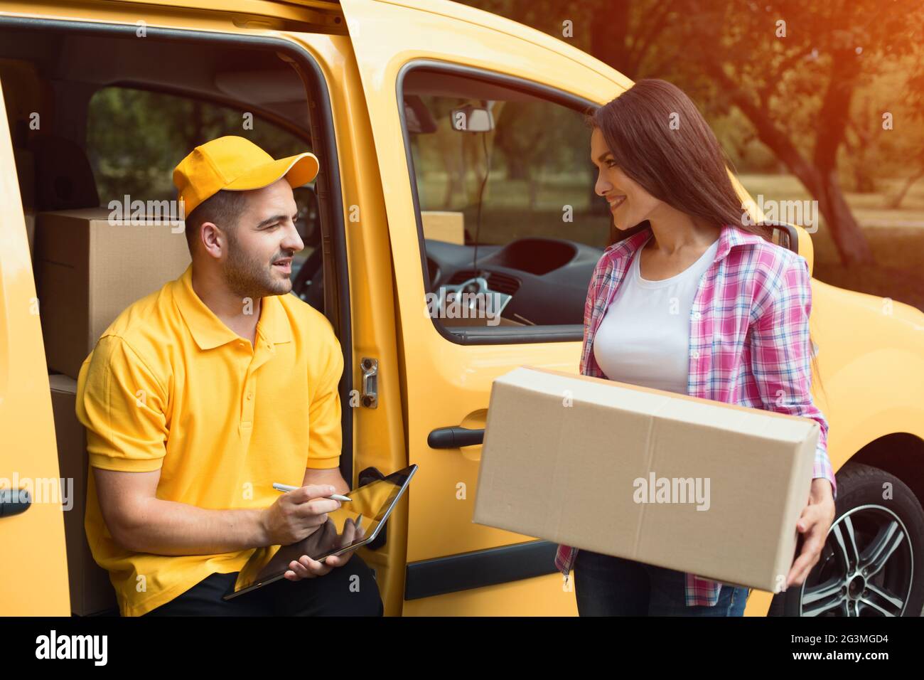 Delivery Man Using Remote Delivery man with digital tablet Stock Photo - Alamy
