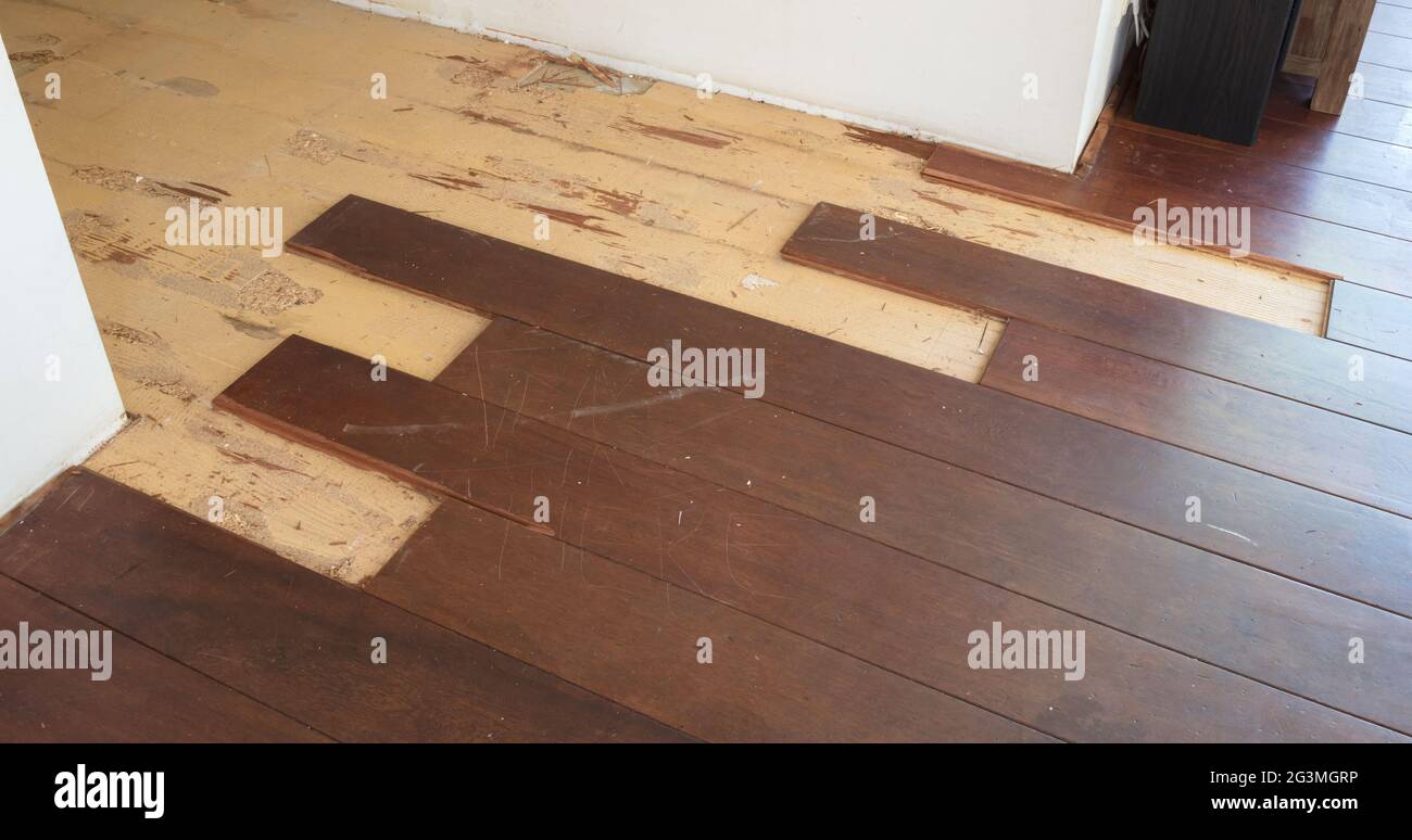Breaking up a solid wooden floor Stock Photo Alamy
