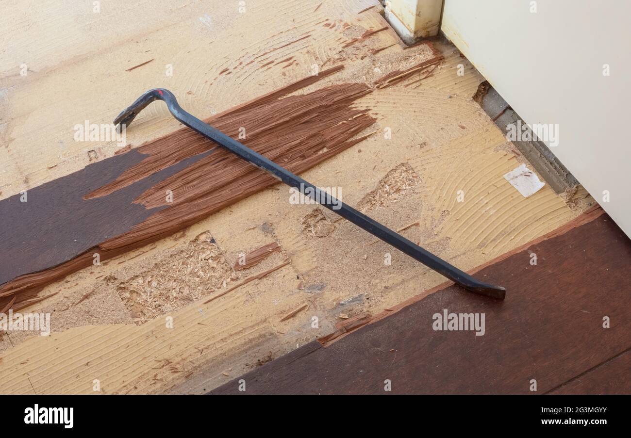 Breaking up a solid wooden floor Stock Photo Alamy