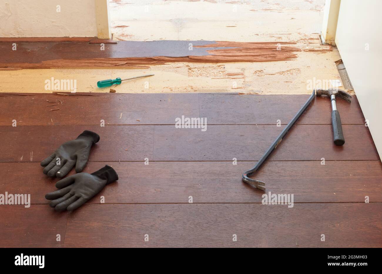Breaking up a solid wooden floor Stock Photo Alamy
