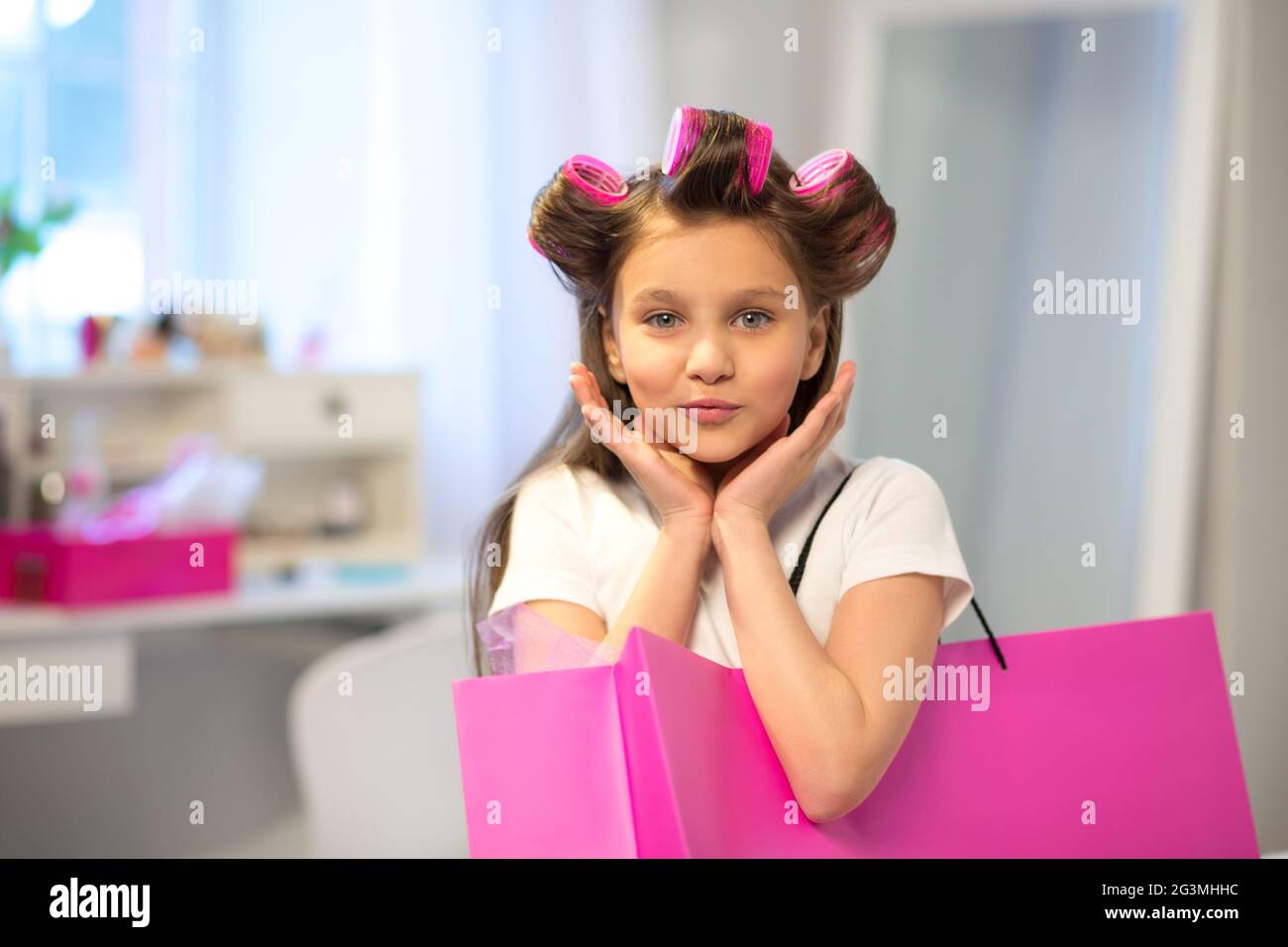 Little girl with pink shopping bag. Stock Photo