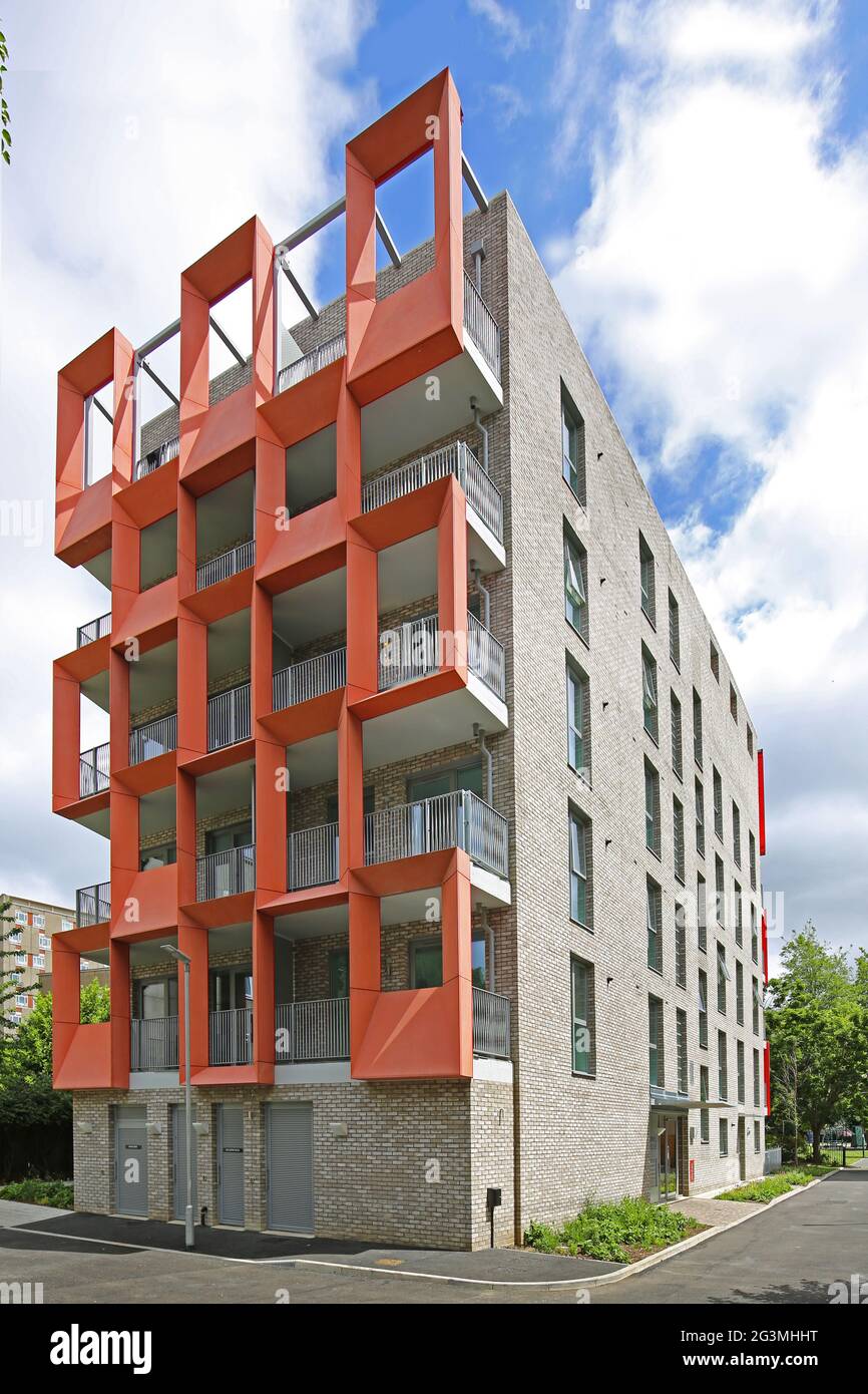Distictive, orange, glass-reinforced cement (GRC) panels on a newly built block of Local Authority apartments in Hackney, London, UK Stock Photo