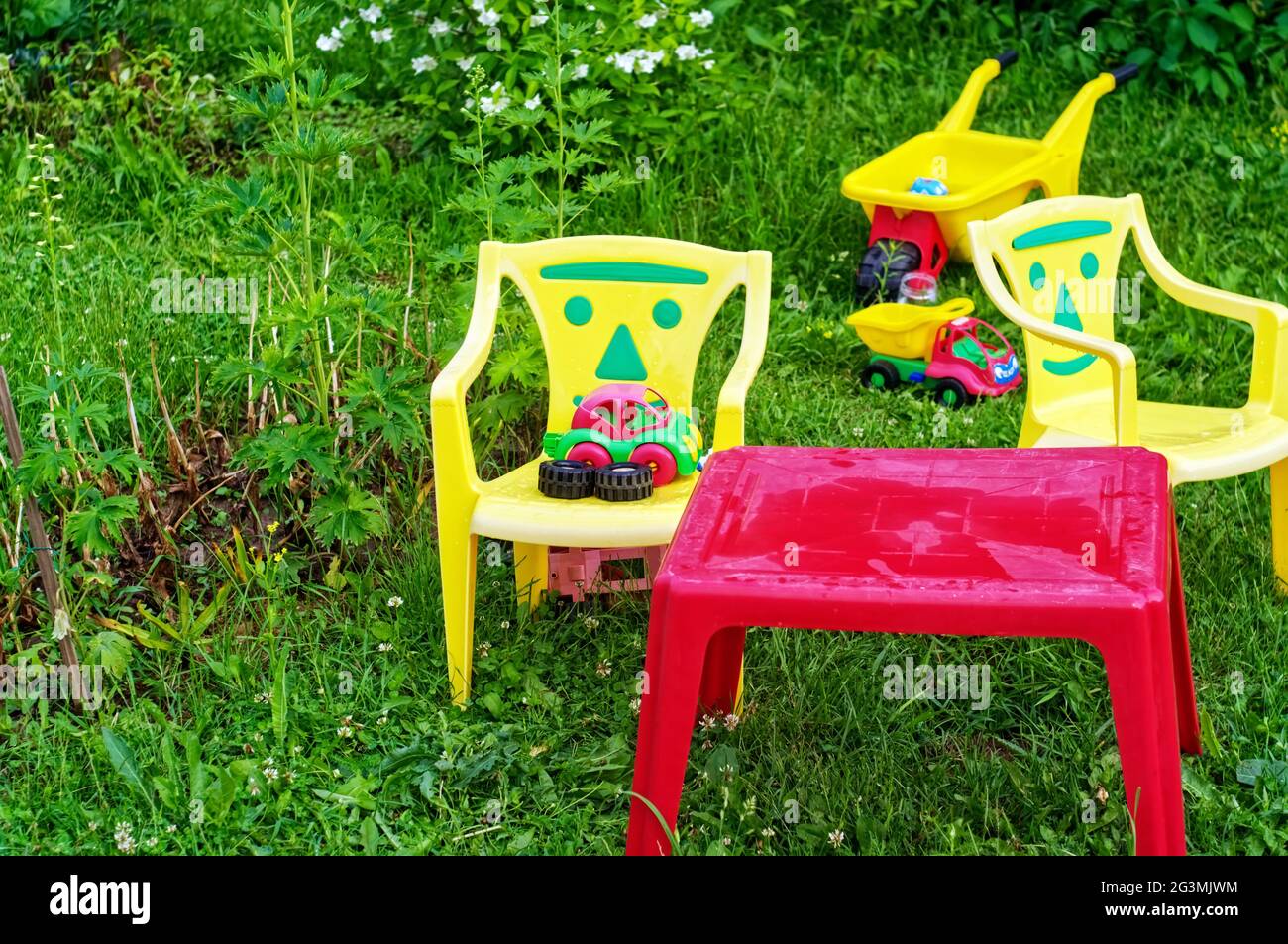 plastic children's play furniture in the garden, in summer Stock Photo