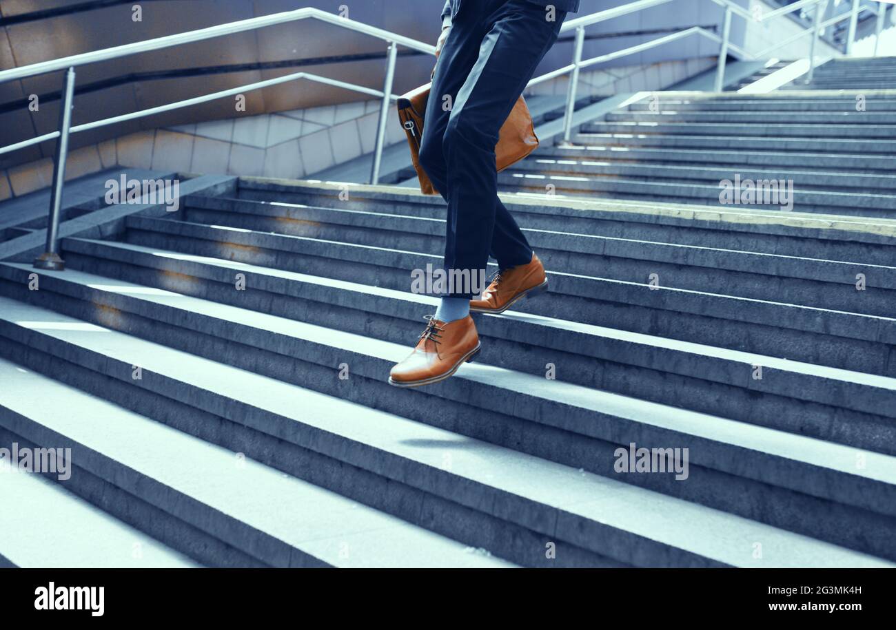 Cropped picture of businessman walking down stairs. Stock Photo