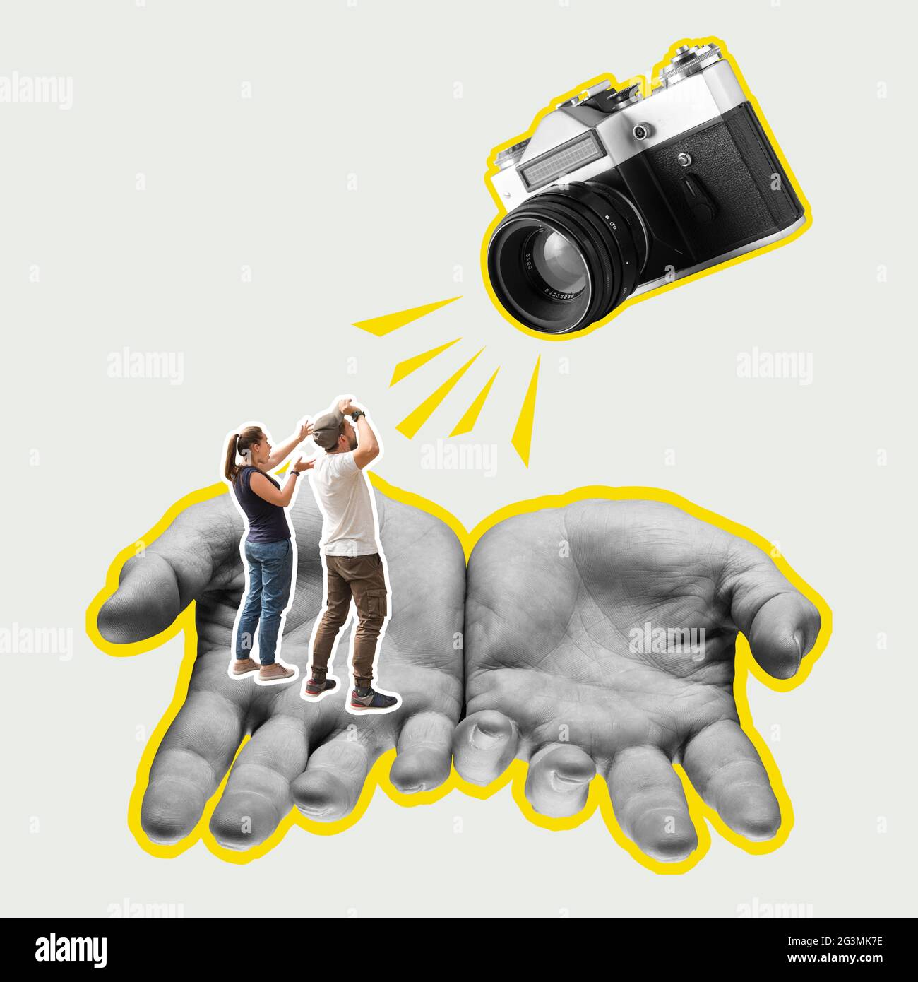 Focus on the male hands. Retro vintage camera and small people. Modern design. Stock Photo