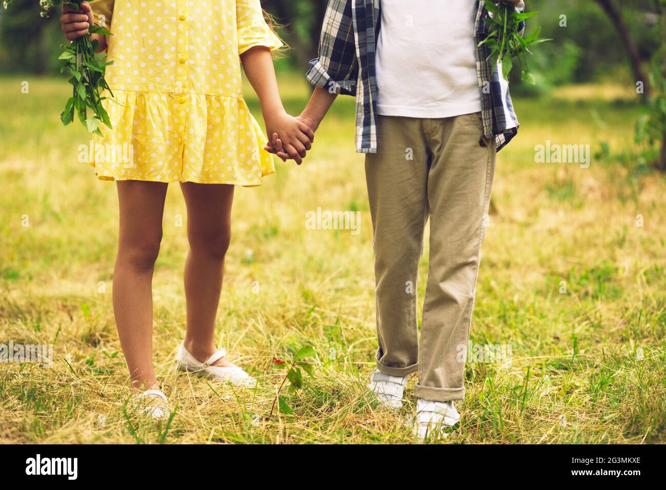 Boy and girl holding hands Stock Photo - Alamy, image size:1300x956