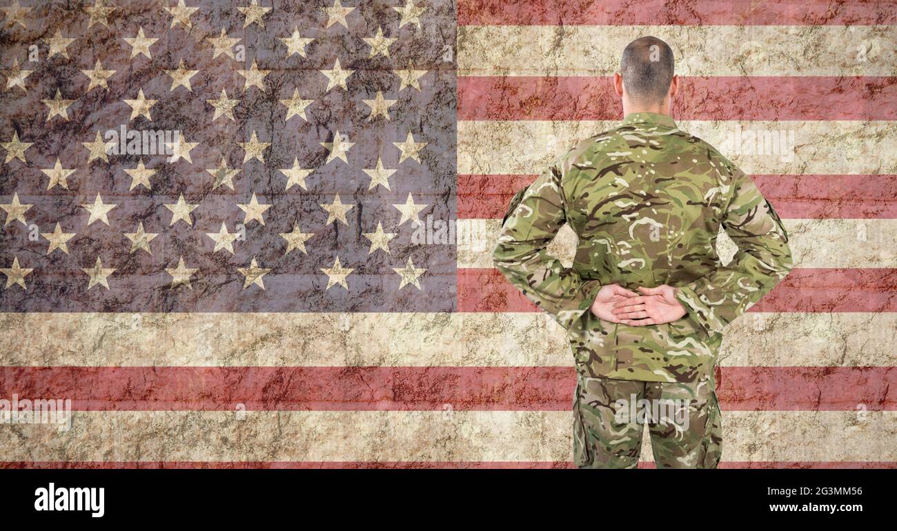 Composition of soldier standing against american flag Stock Photo - Alamy
