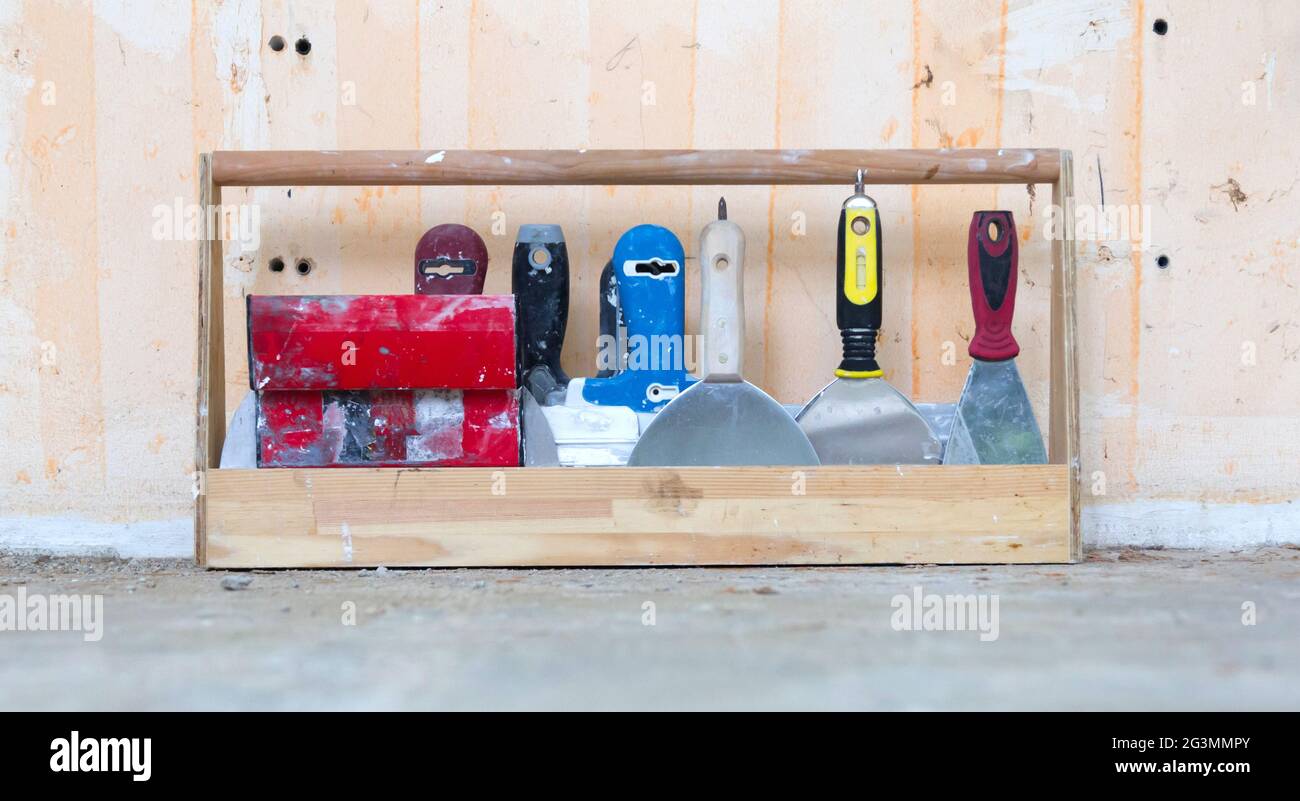 Rack full of tools use for plastering a wall Stock Photo - Alamy
