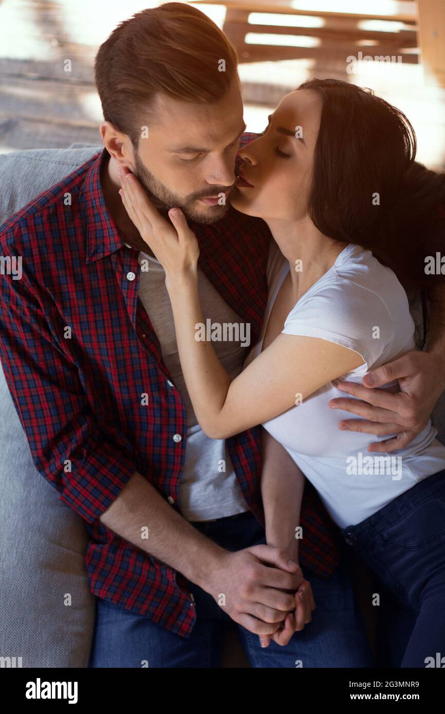 Happy couple sitting on couch. Stock Photo