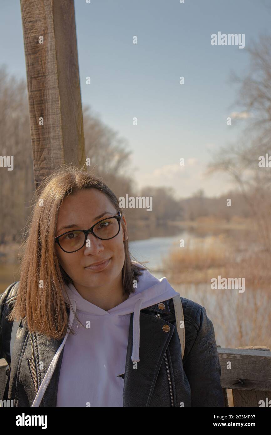 A portrait of a beautiful girl with glasses with nature in the background Stock Photo