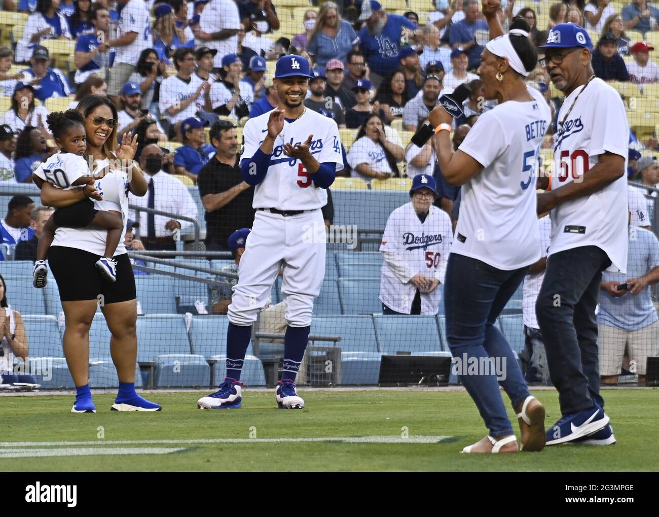 Tommy Lasorda presents Mark Walter (L) with a Dodger jersey as Steve Garvey  presents Irvin Magic Johnson with one as the new owners of the Los  Angeles Dodgers, known as the Guggenheim