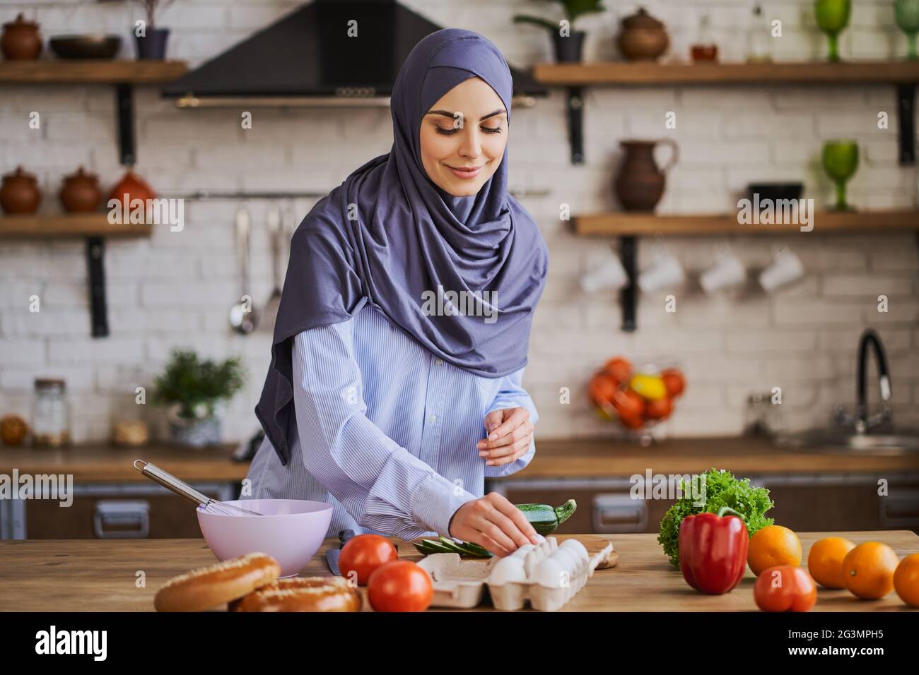 Muslim housewife cooking a meal in the kitchen Stock Photo Alamy