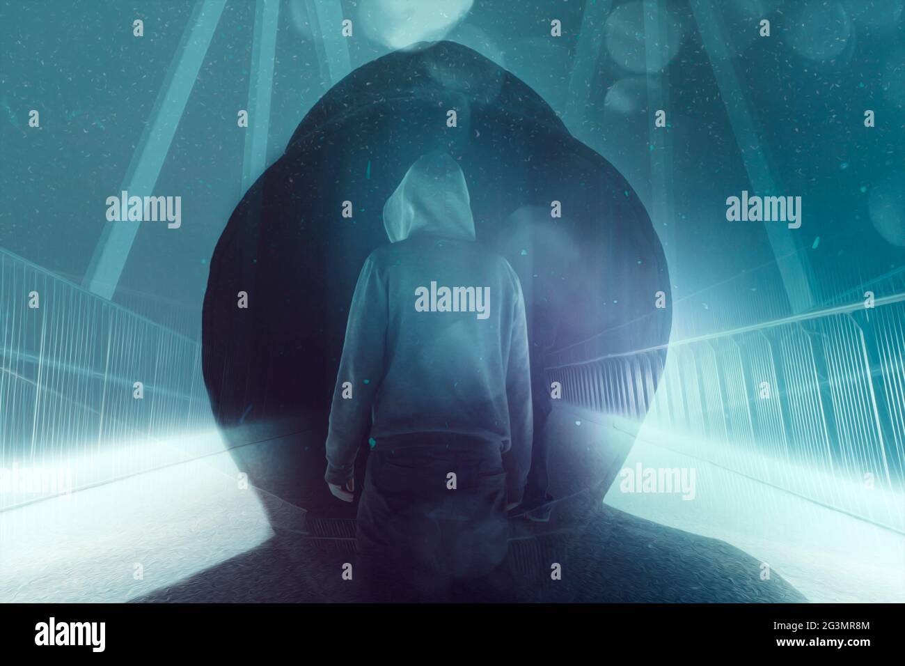 A double exposure of a mysterious hooded figure standing  on a path on a bridge. Silhouetted against bright lights at night. With a neon, retro, scien Stock Photo