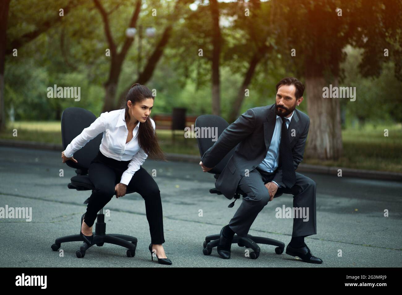 Businesspeople having racing on office chairs Stock Photo