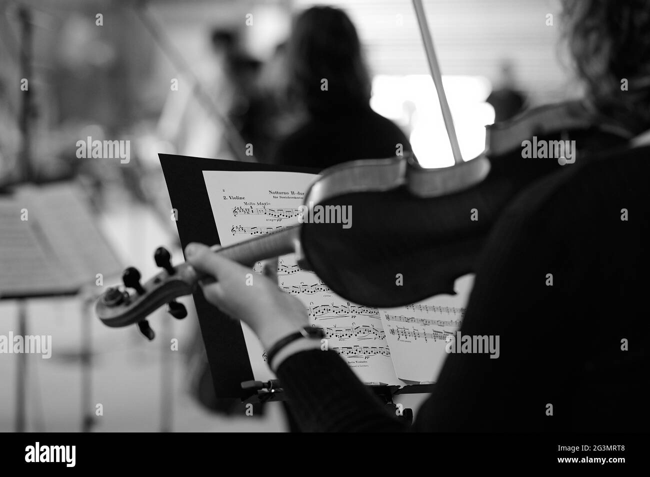 A violinist playing classical music on a music stand Stock Photo Alamy