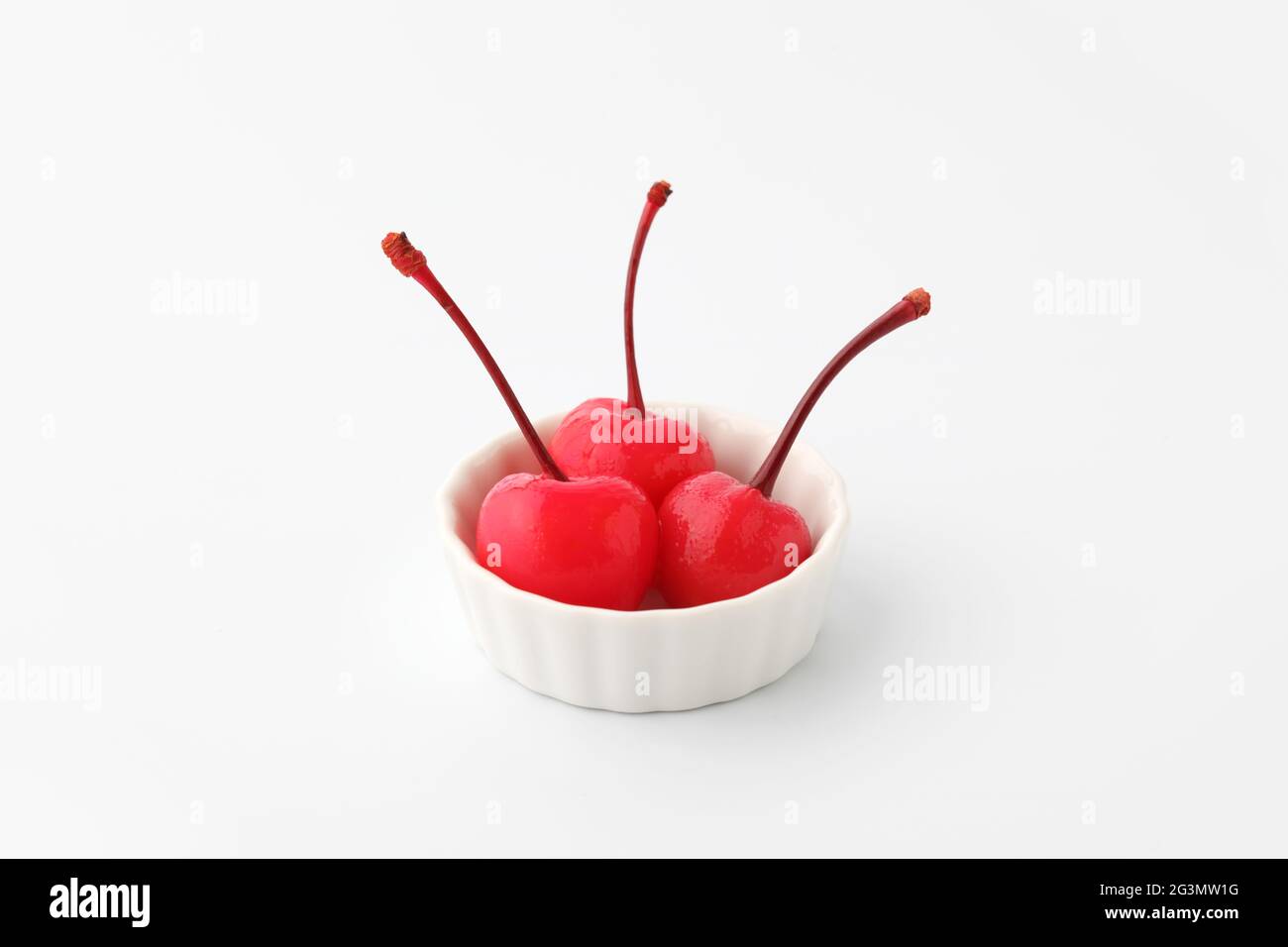 canned red cherries in syrup on plate isolated on white background