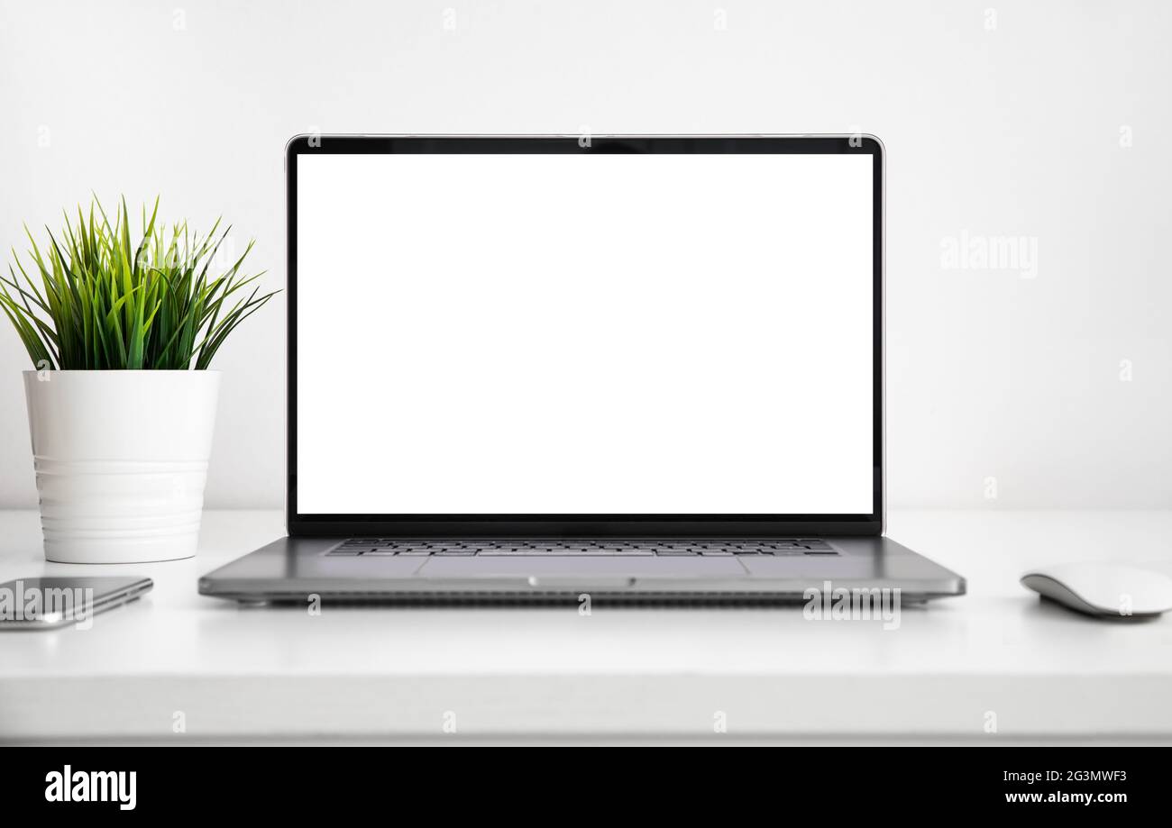Laptop with a blank screen on white wooden table with mouse, smartphone ...