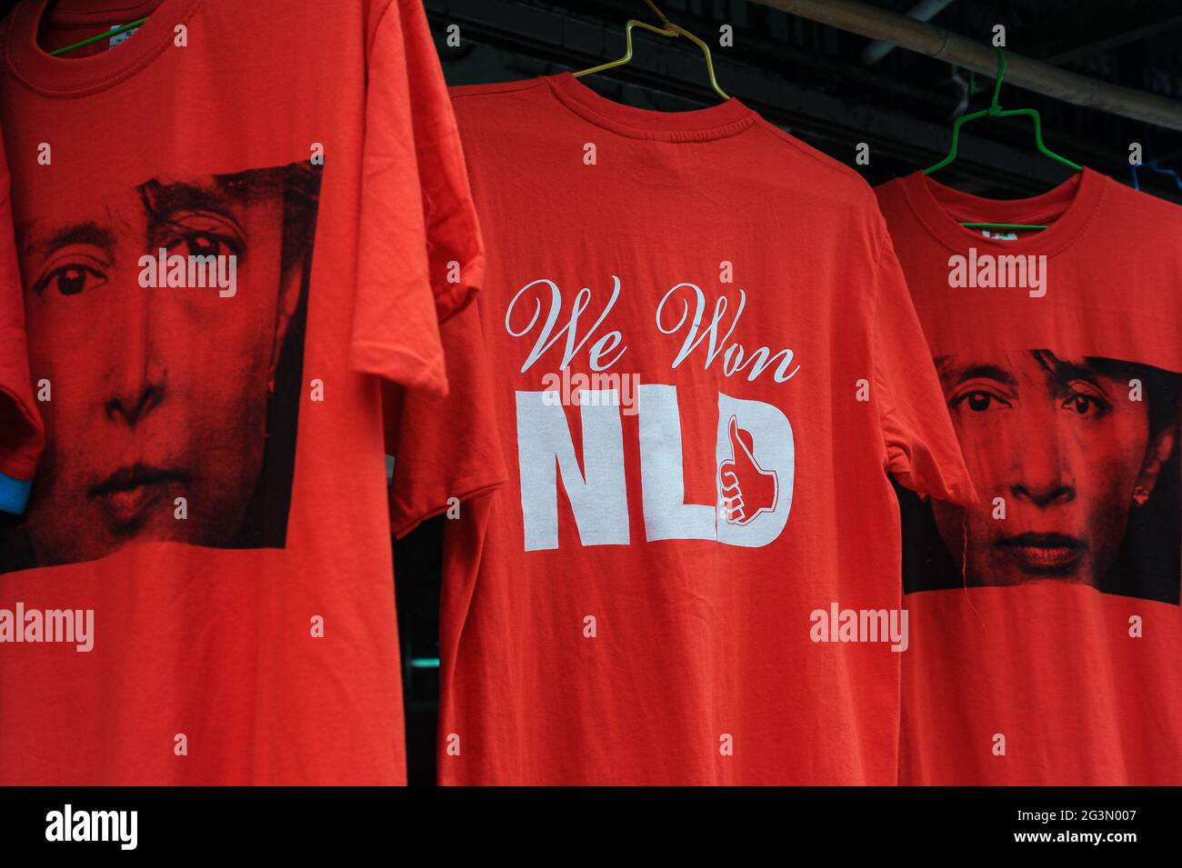 "10.11.2015, Yangon, , Myanmar - Red T-shirts bearing the image of Aung San Suu Kyi and the words 'We Won NLD' are for sale at a street stall in the f Stock Photo