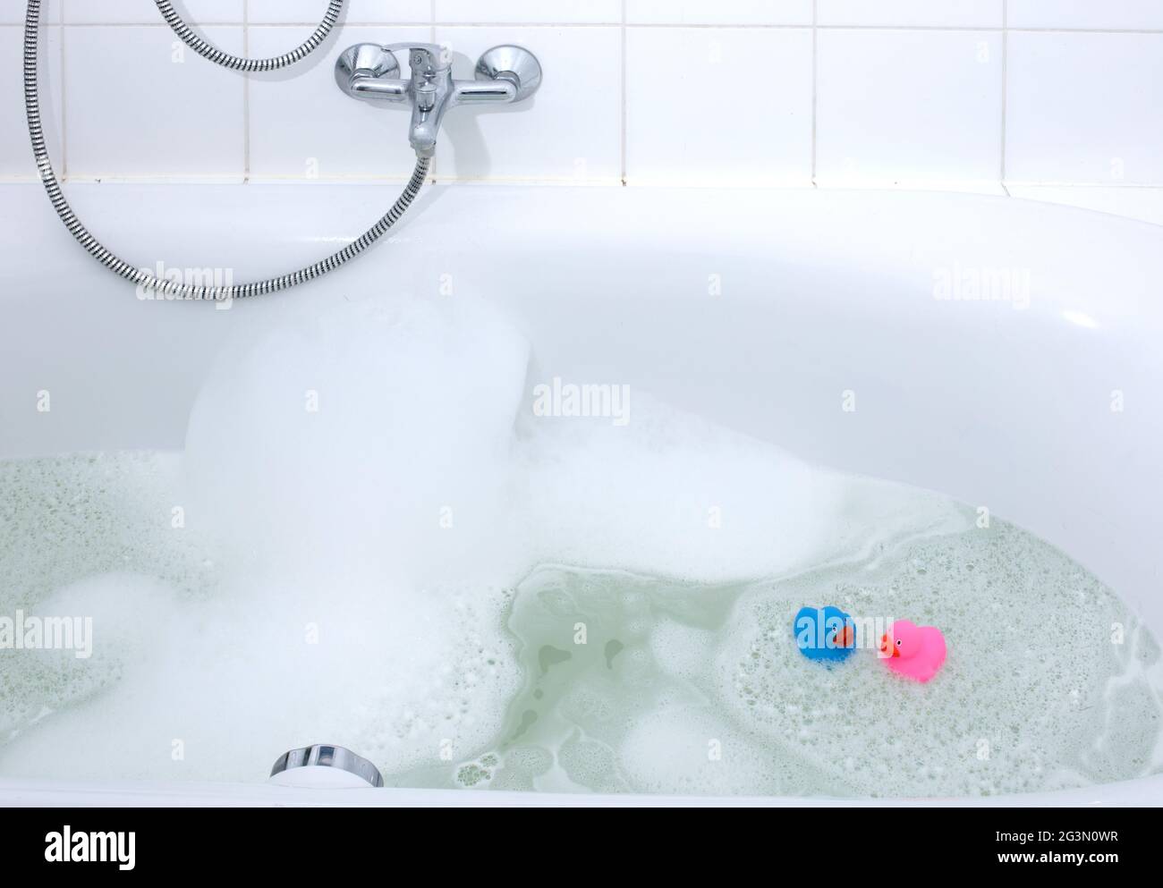 Pink and blue duck in a bathtub Stock Photo - Alamy