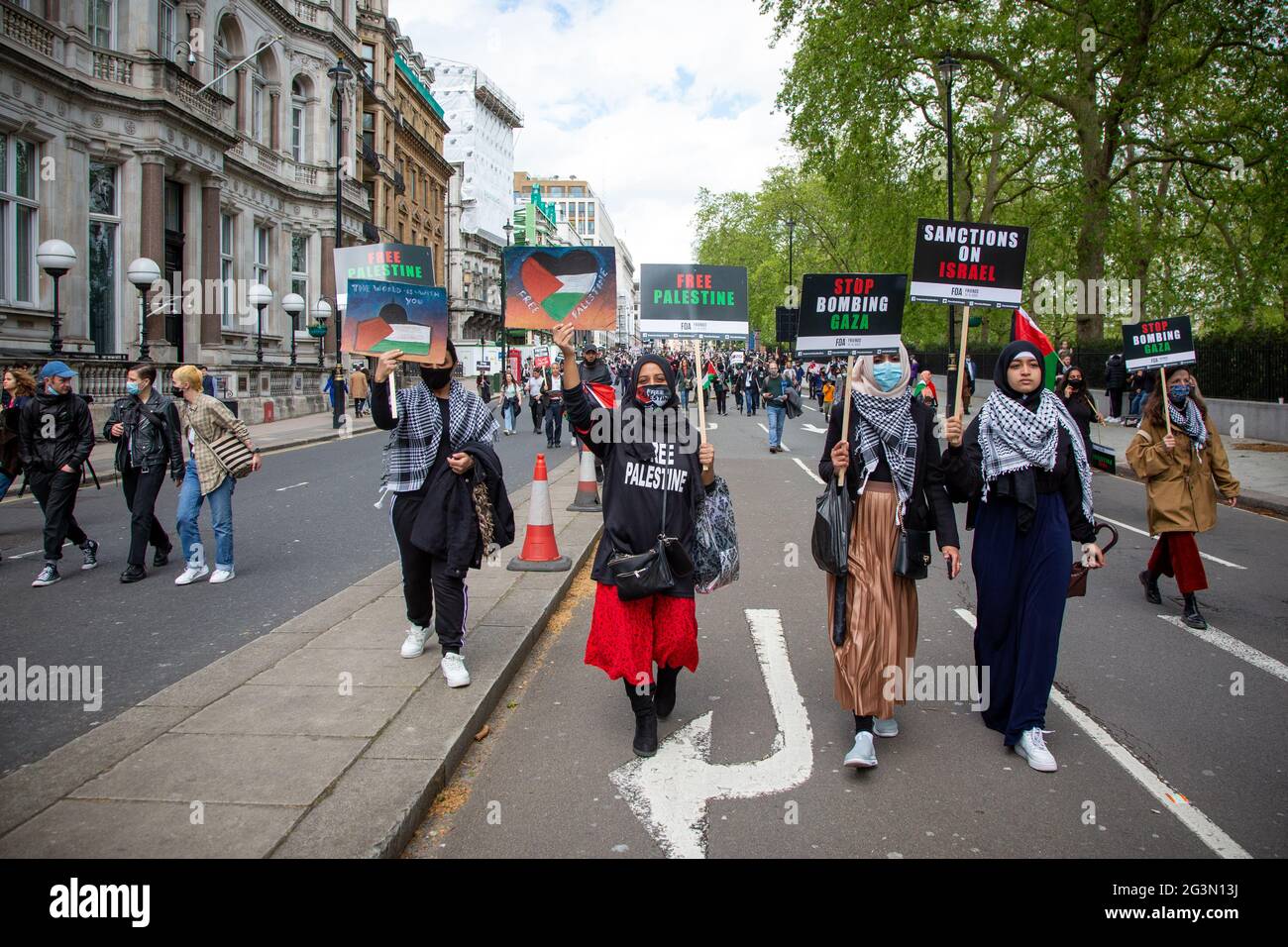 Women wearing hijabs and keffiyeh holding up signs at the Free Palestine Protest in London, UK 22.5.2021 Stock Photo