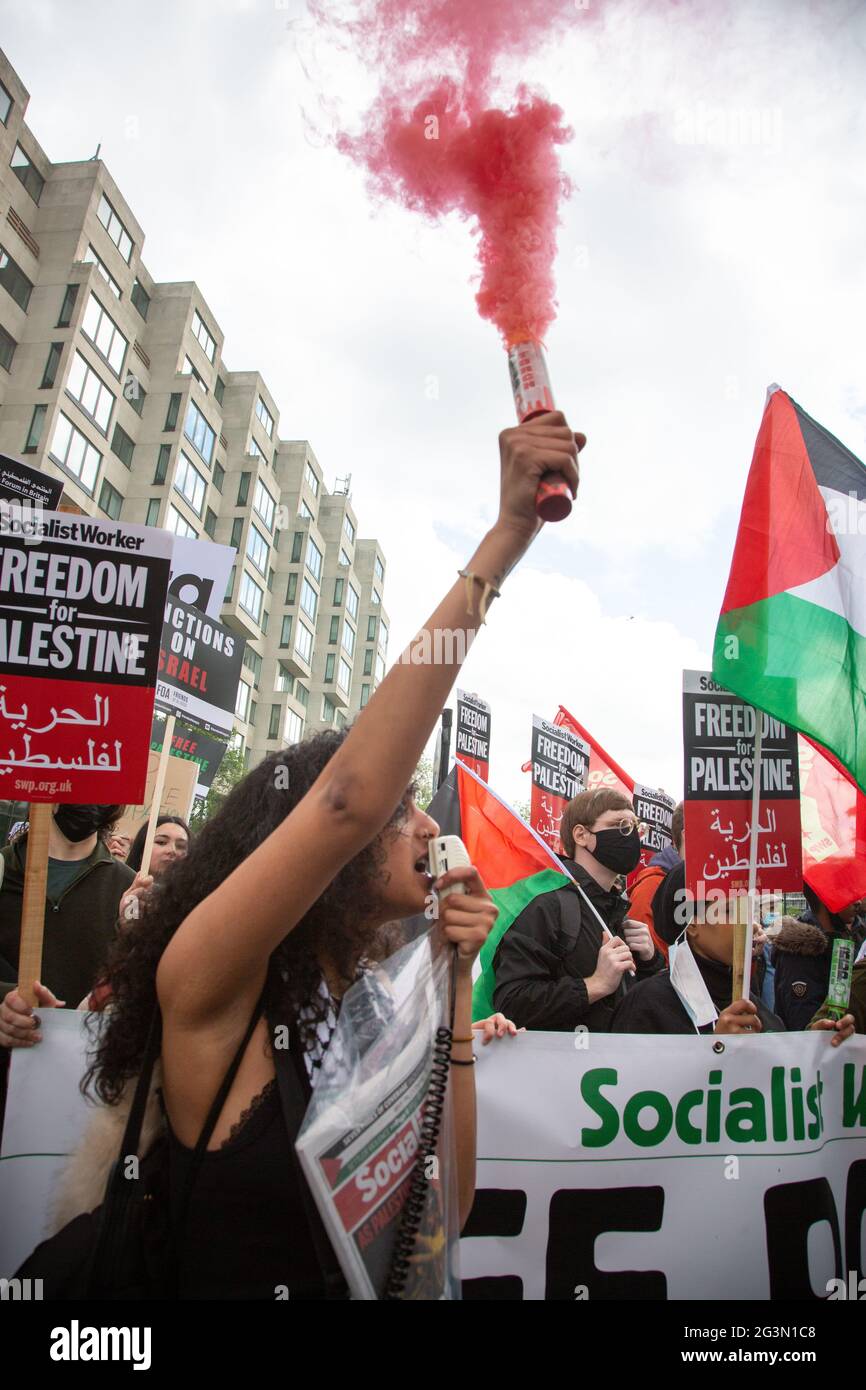 A woman holding a red smoke flare at the Free Palestine Protest in London, UK 22.5.2021 Stock Photo
