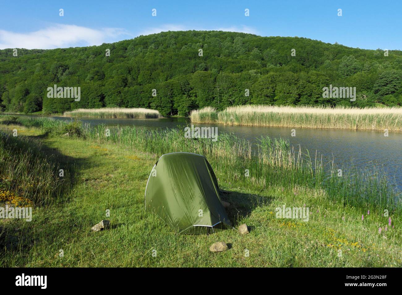 outdoor adventure in tent in the Sicily nature, wild camp by a lake in Nebrodi mountains Stock Photo