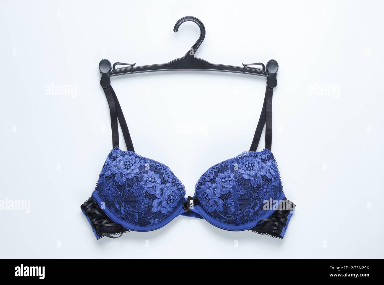 Sexy bra with hanger on white background. Top view Stock Photo - Alamy