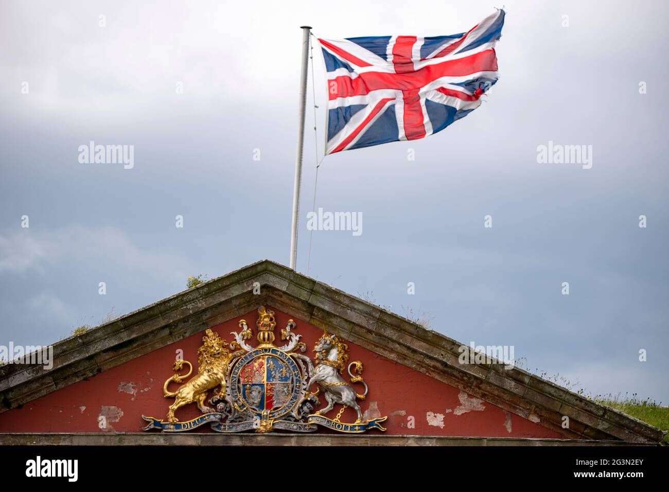 Fort George, Inverness, Scotland, UK. 13 June 2021. Pictured: Union Jack flag flying in the wind seen at Fort George with the Fort George crest which reads, HON SOIT QUI MAL Y PENSE, DIEU ET MON DROIT. Scenes from Fort George.  Credit: Colin Fisher/CDFIMAGES.COM Stock Photo