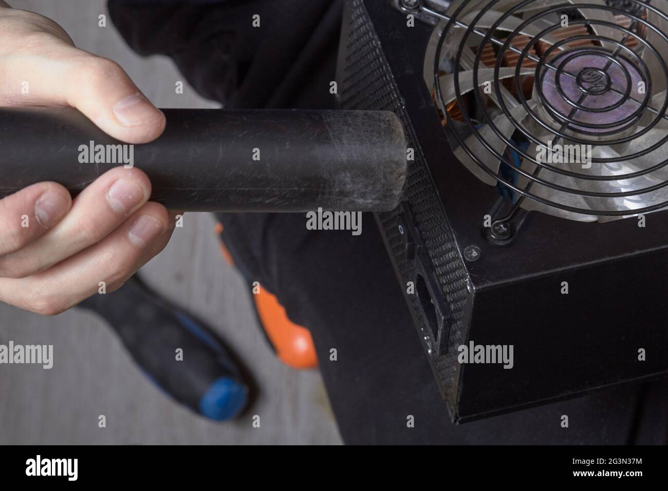 Cleaning the computer power supply from dust with a brush Stock Photo