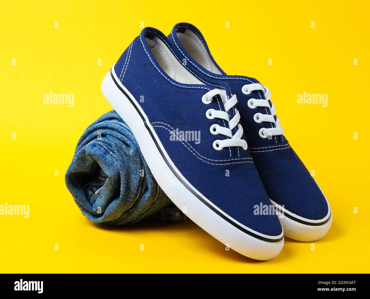 Fashionable sneakers with rolled jeans 