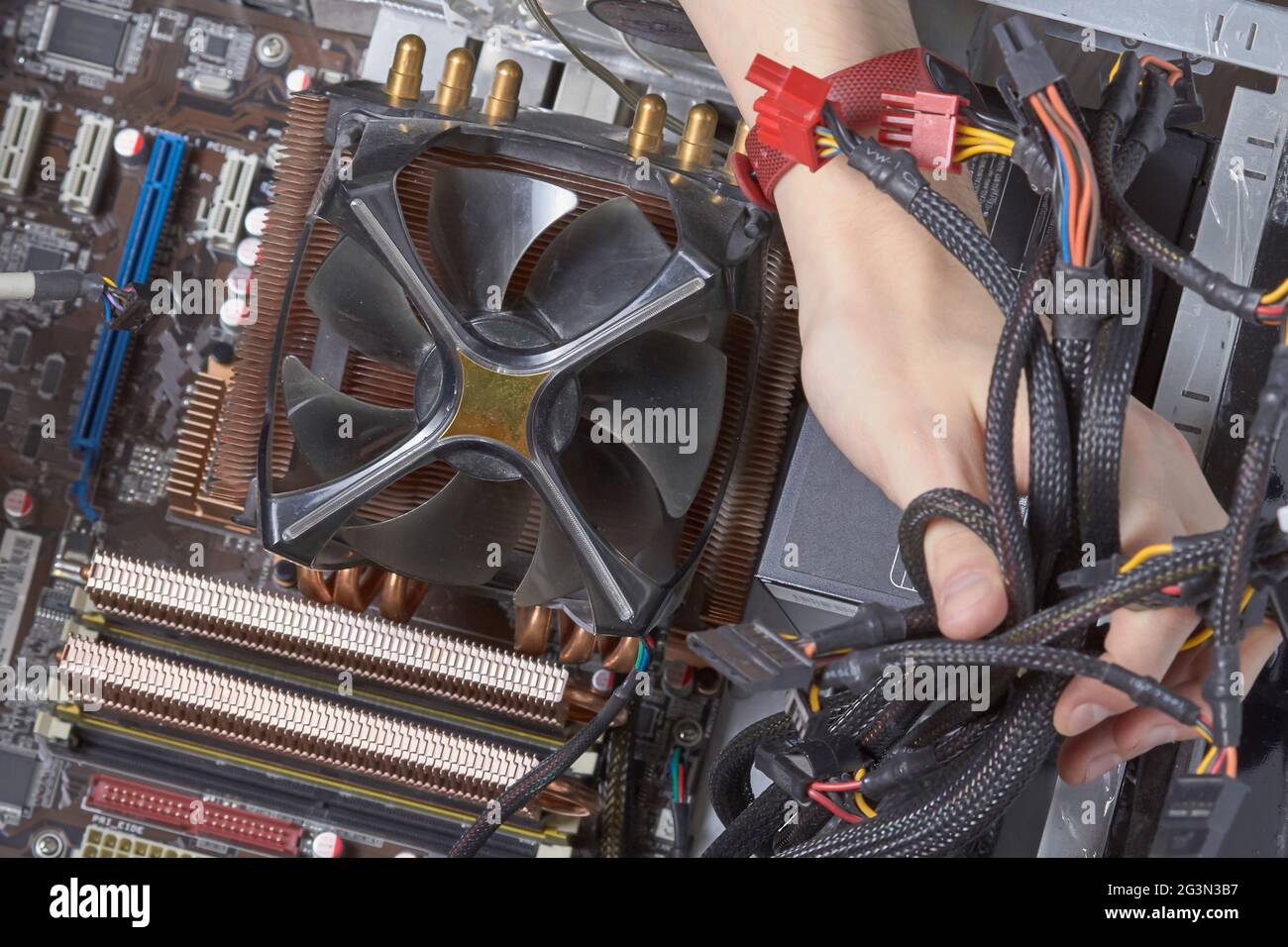 Cleaning the computer power supply from dust with a brush. Stock Photo