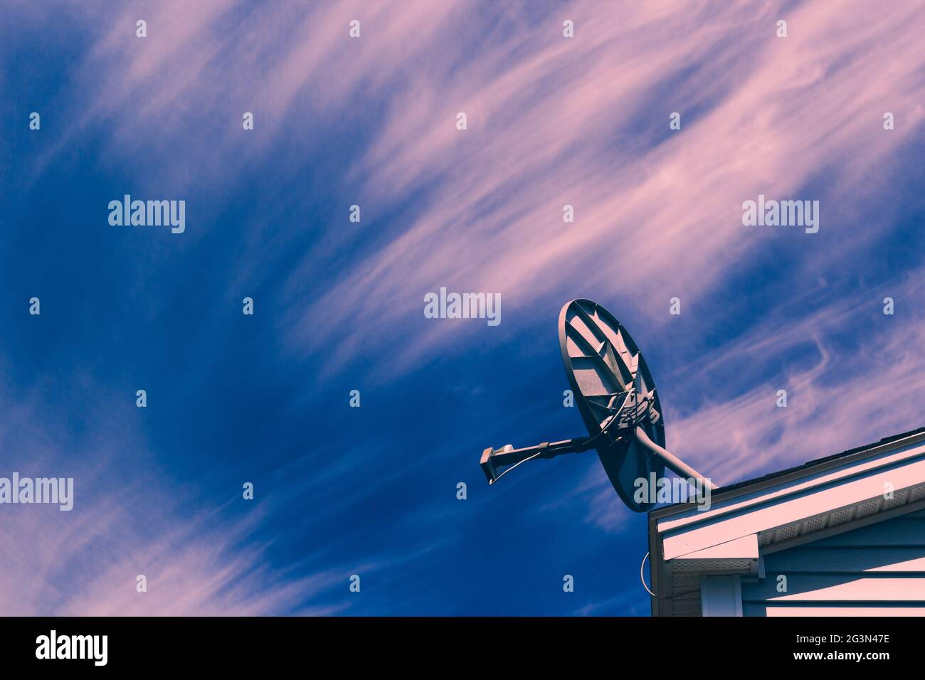 Satellite dish on roof and sky. Stock Photo