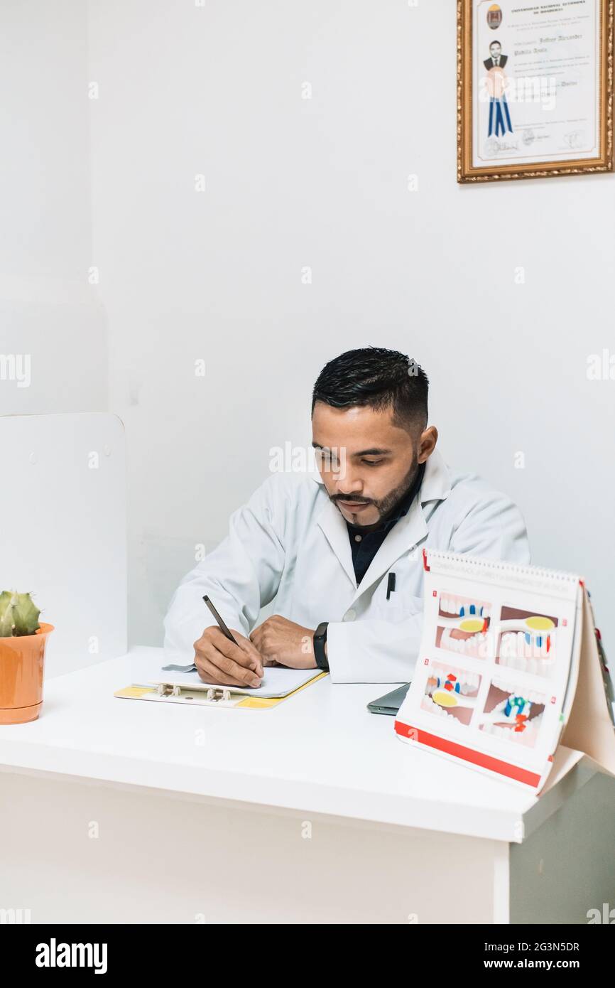 Doctor notes hispanic patient hi-res stock photography and images - Alamy