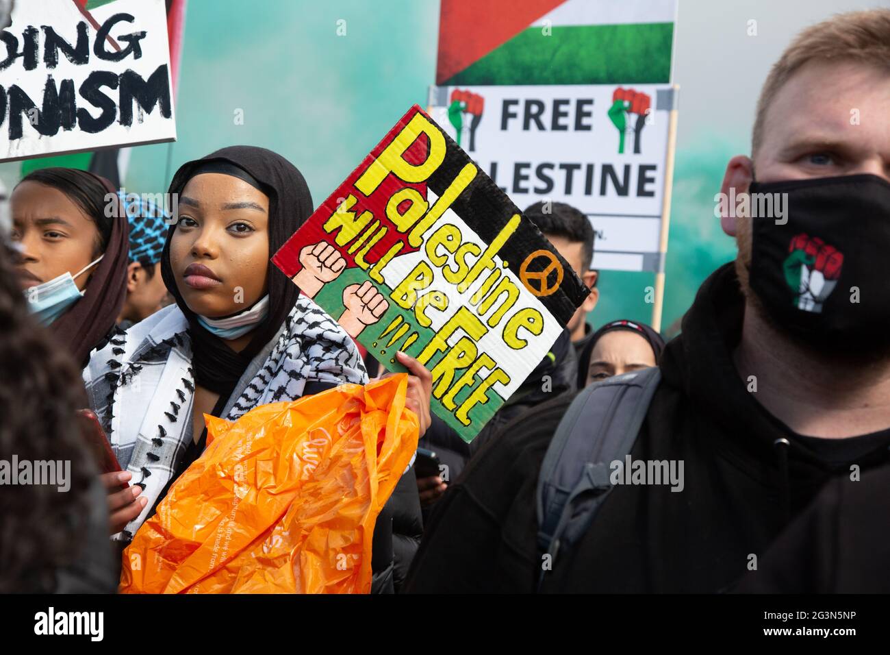 Protesters holding up hand made signs at the Free Palestine Protest