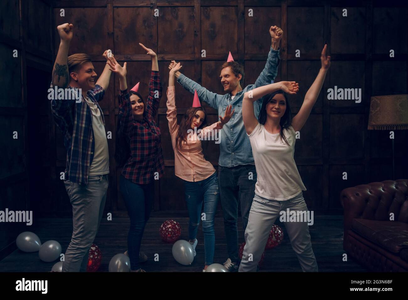 Group of friends dance at birthday party Stock Photo